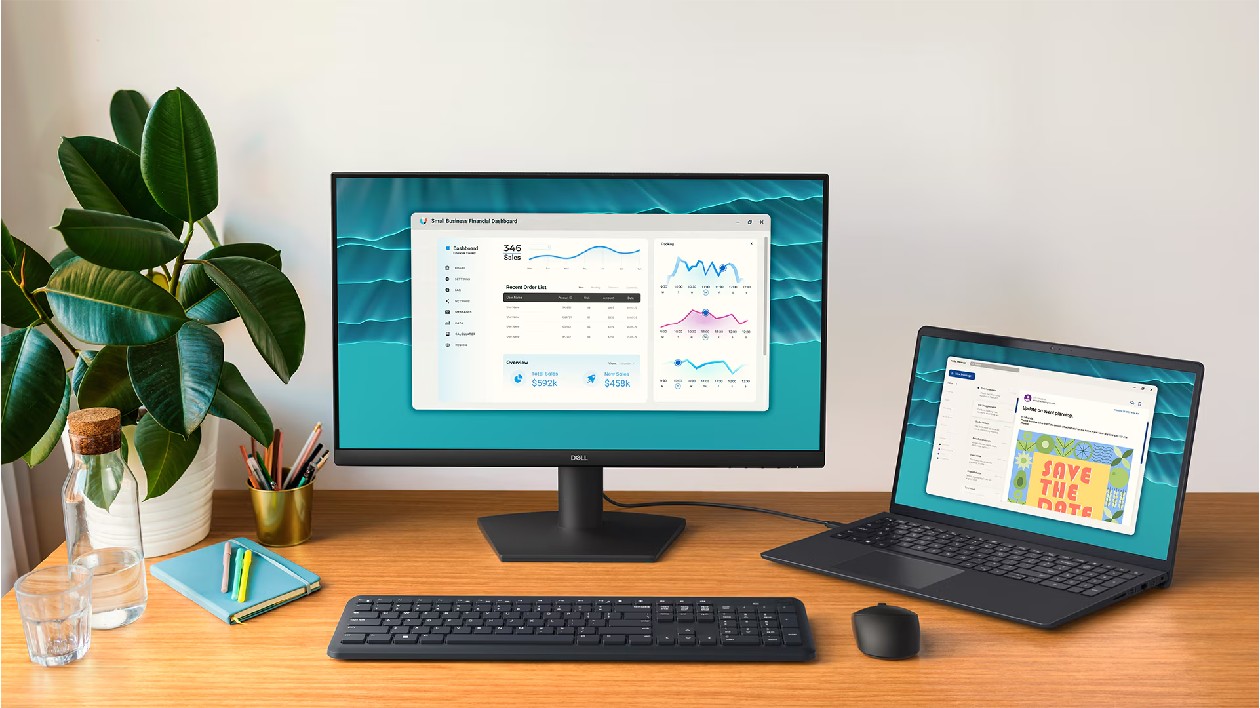 Monitor Dell SE2426H preto em setup de escrit&oacute;rio com laptop teclado mouse e acessorios exibindo dashboard na tela